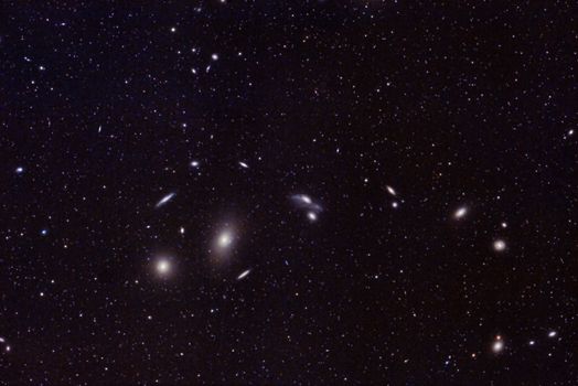 Captivating image of distant galaxies and star clusters in the vast universe. Perfect for astronomy enthusiasts.