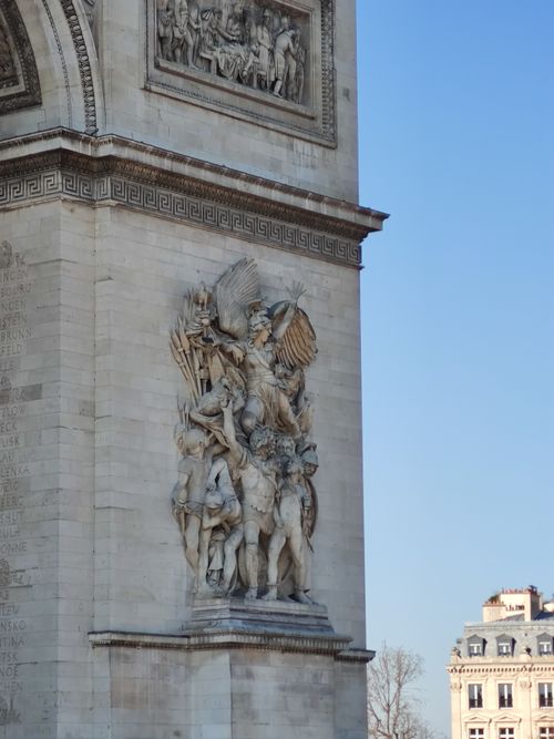 Free Close-up of intricate sculptures on the Arc de Triomphe in Paris, under a clear blue sky. Stock Photo