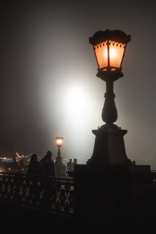Streetlamp on a bridge at night in the fog