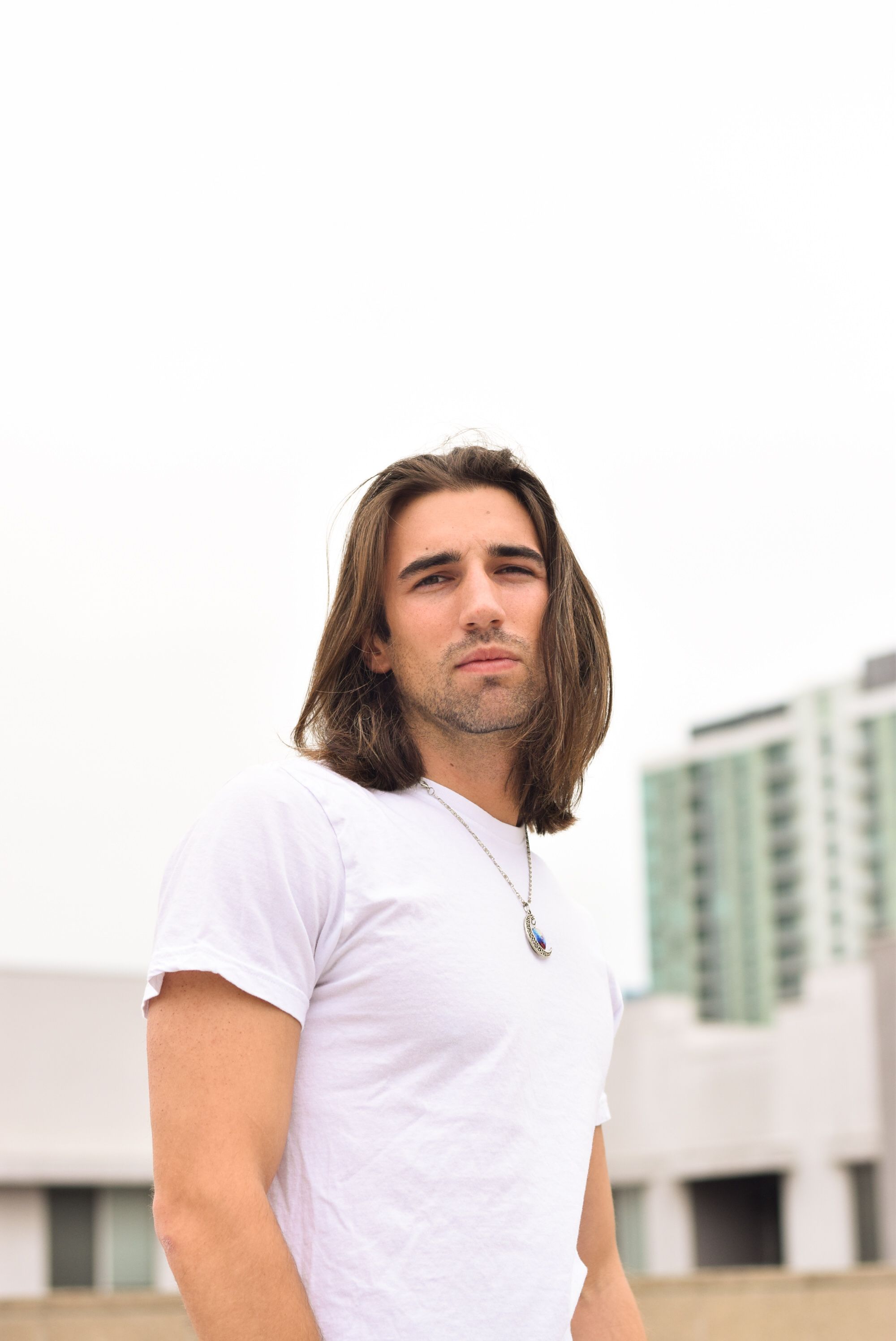 Portrait of a Young Man with Long Hair · Free Stock Photo