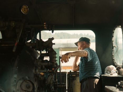 A man in a train engine room