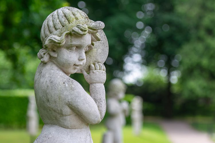 Sculpture Of A Cherub In The Palace Garden