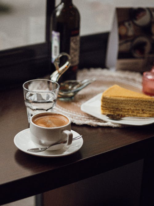 Cup of Coffee and Cake Slice on Table