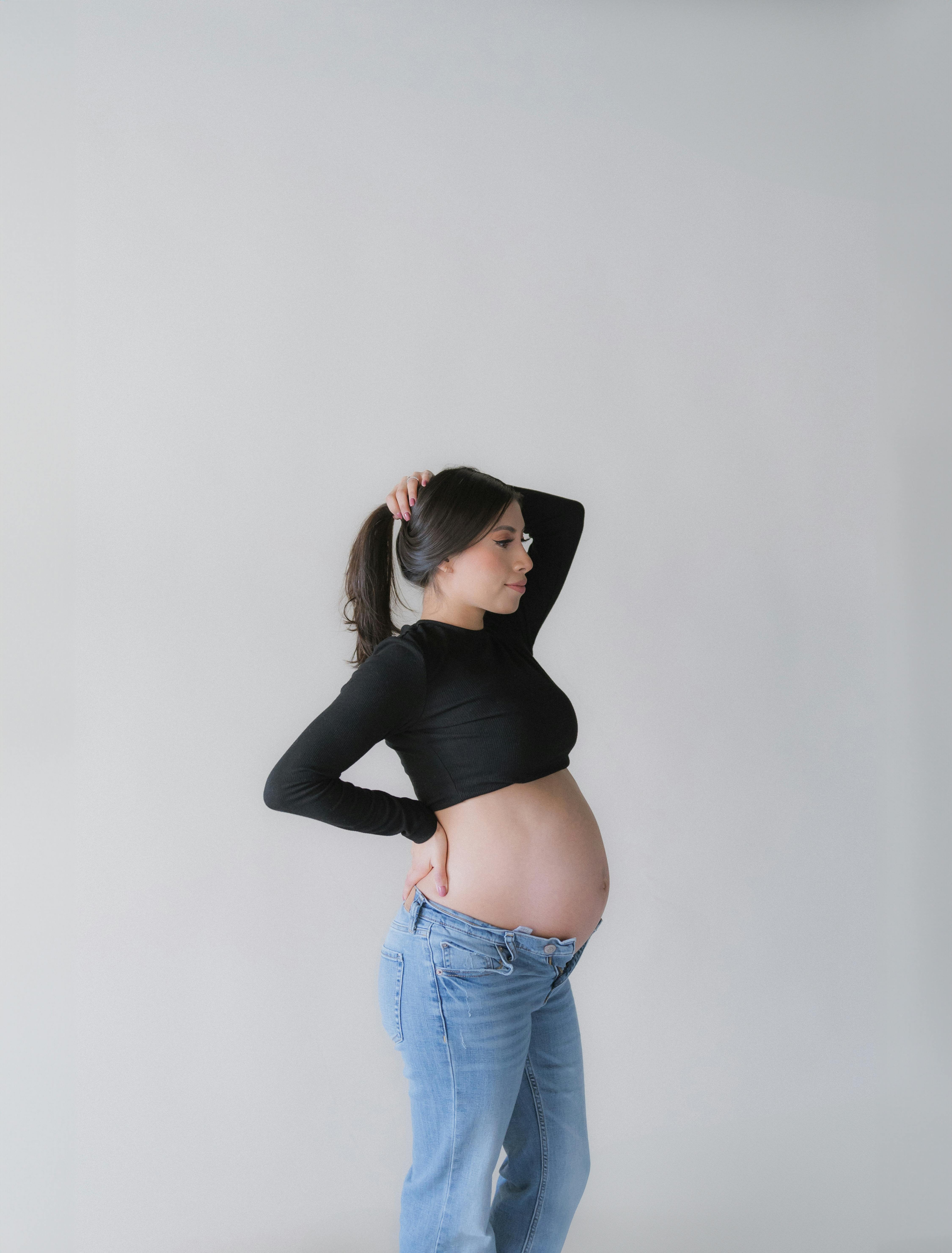 pregnant brunette showing belly