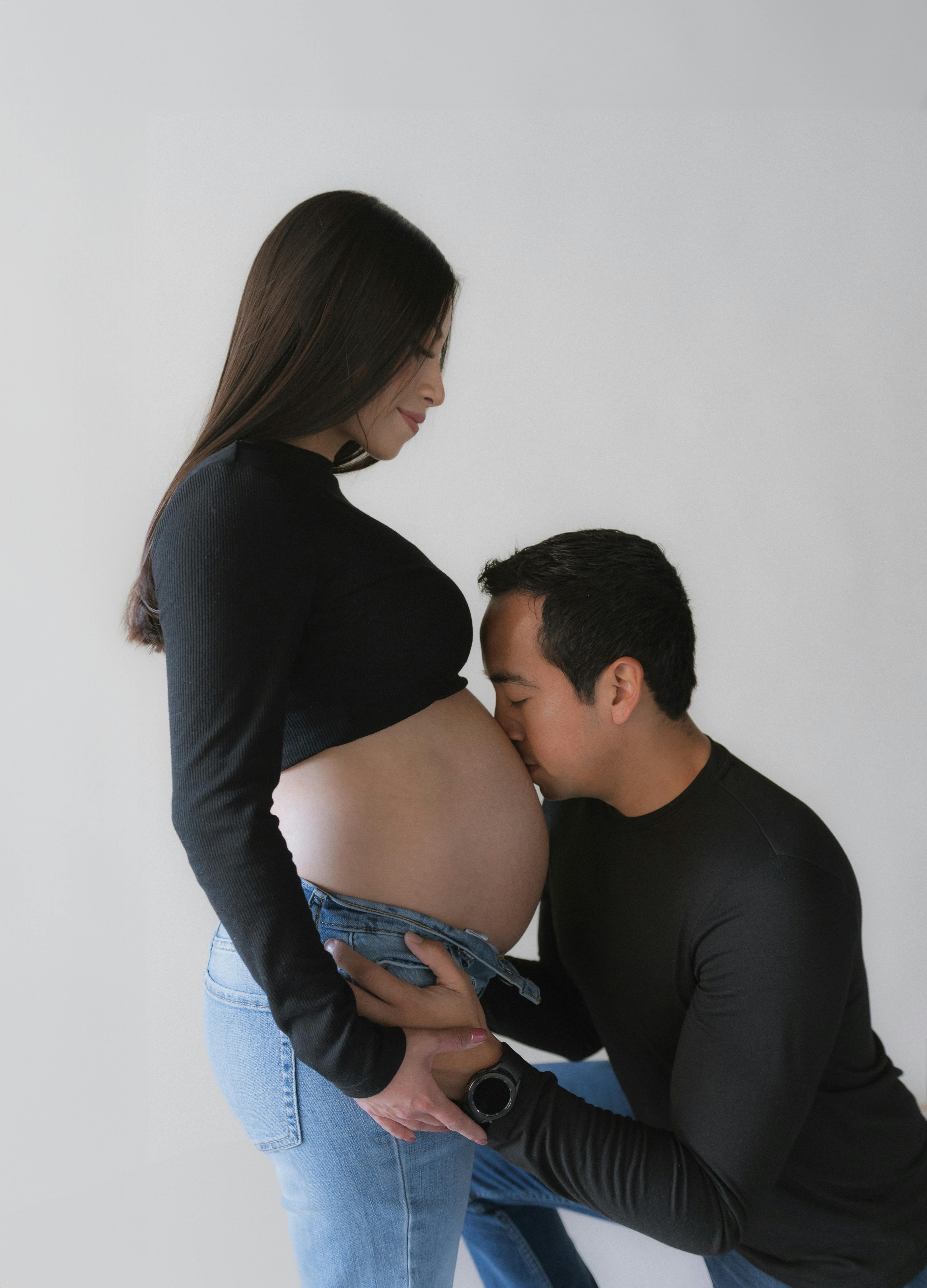 Man Kissing the Stomach of His Pregnant Wife · Free Stock Photo