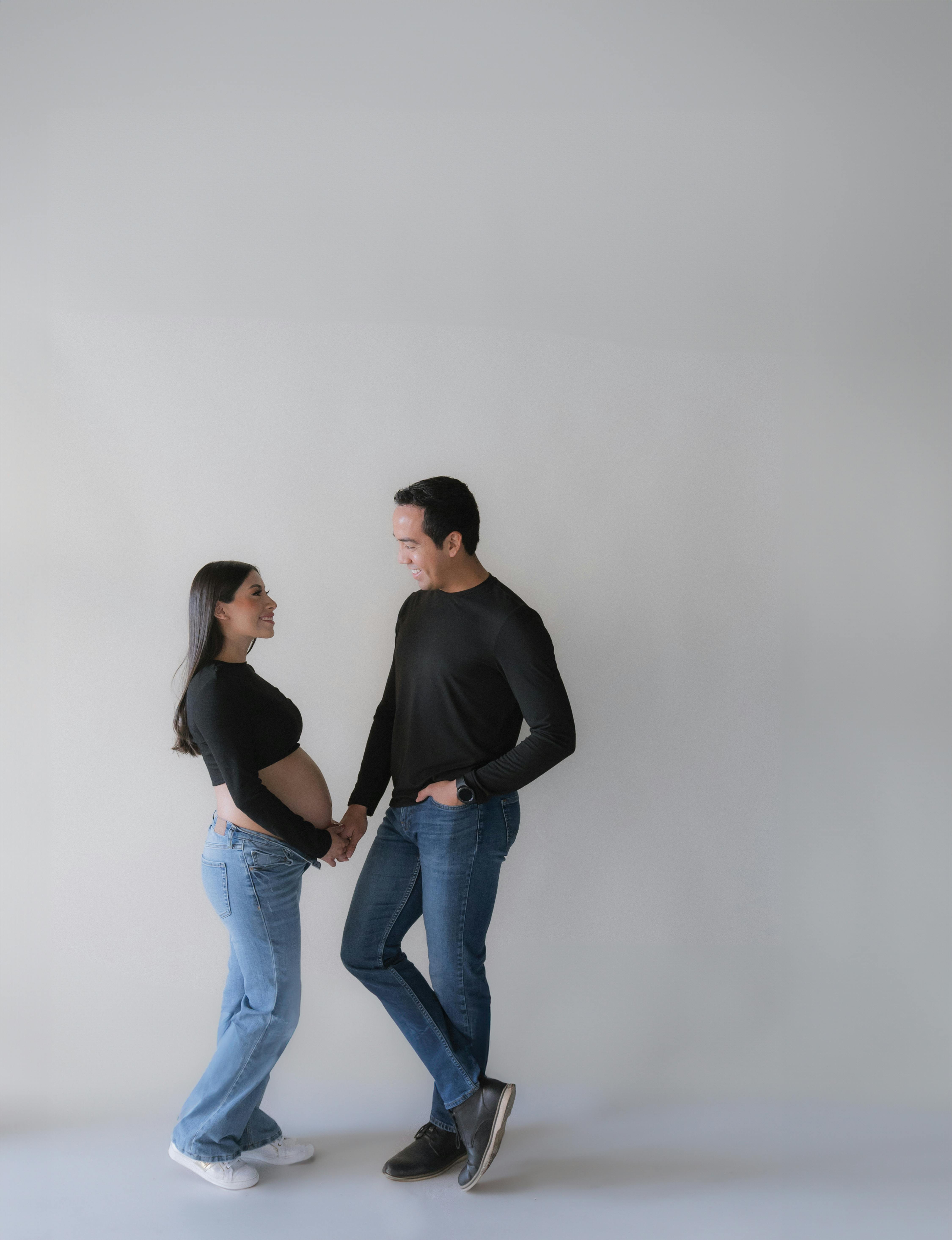 Black and White Shot of a Husband and a Pregnant Wife Standing Face to Face  · Free Stock Photo