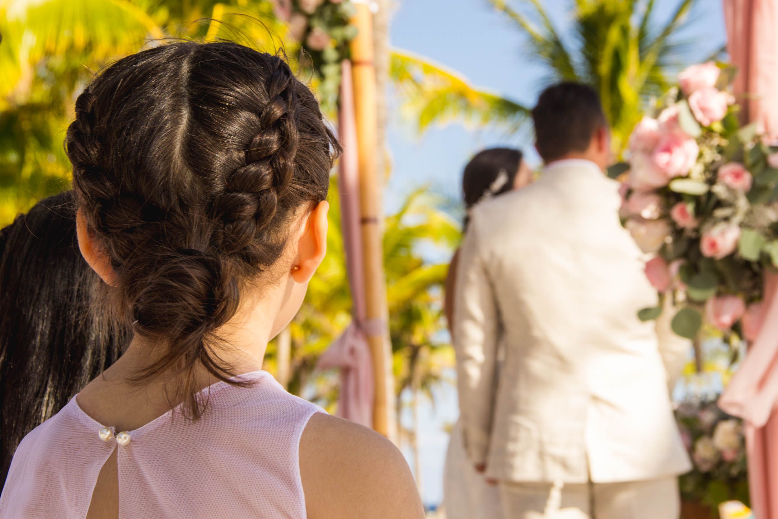 Beach wedding ceremony with floral arch and tropical Caribbean setting in Cancún, Mexico
