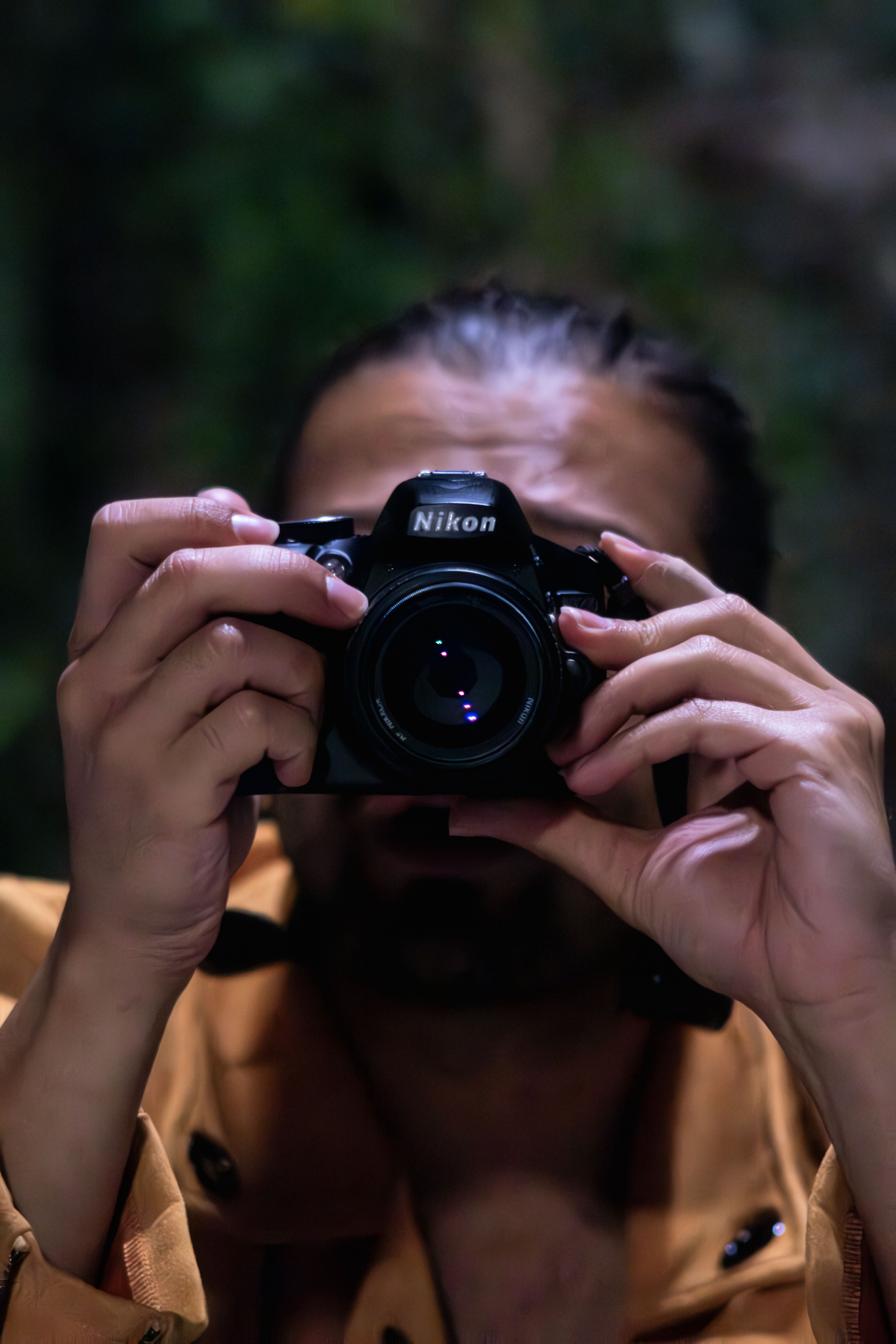 Close-up view of a man holding a camera capturing a photo, shot outdoors in Toronto.