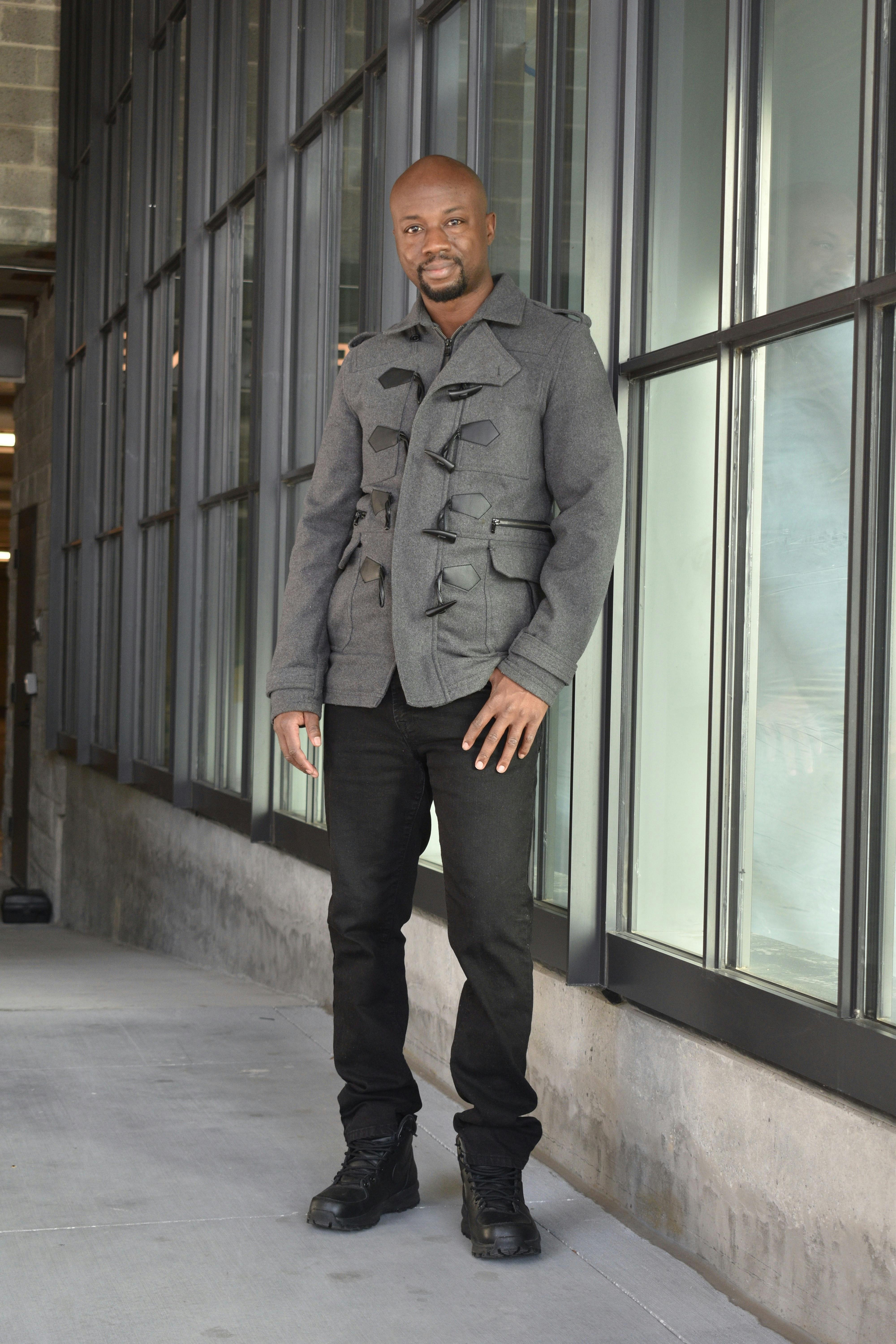 Free African man standing confidently in trendy fashion outfit in an urban environment. Stock Photo
