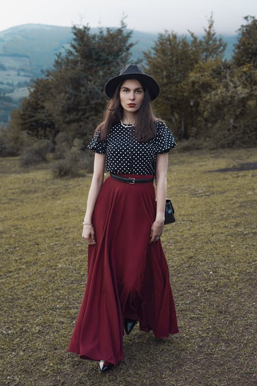 Model in a Black Polka-dot Blouse and a Burgundy Long Skirt
