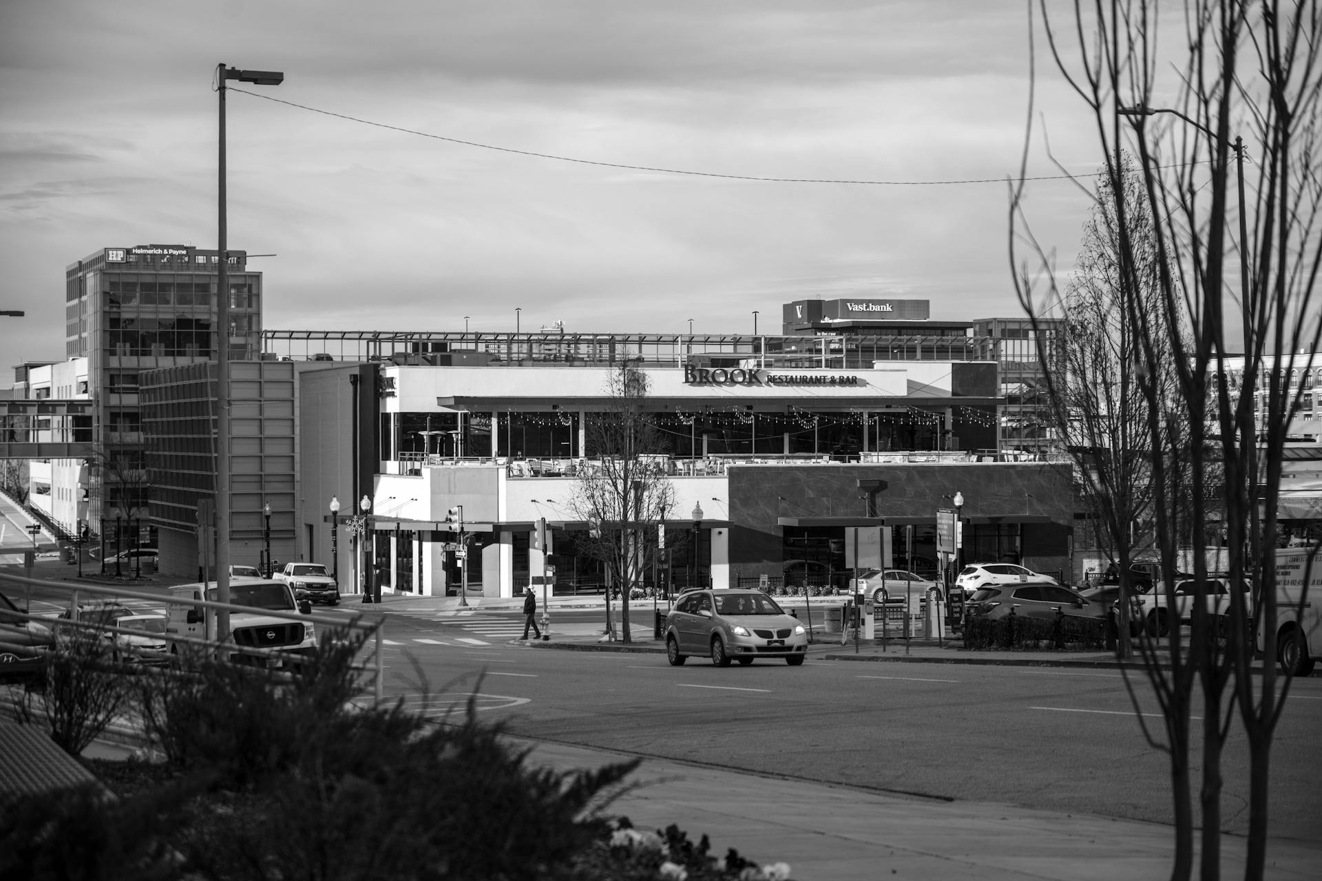 Black and white view of Tulsa's urban cityscape featuring a busy street and modern architecture.