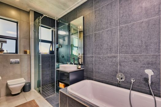 A sleek and stylish bathroom design featuring a bathtub and glass shower in Pretoria, South Africa.
