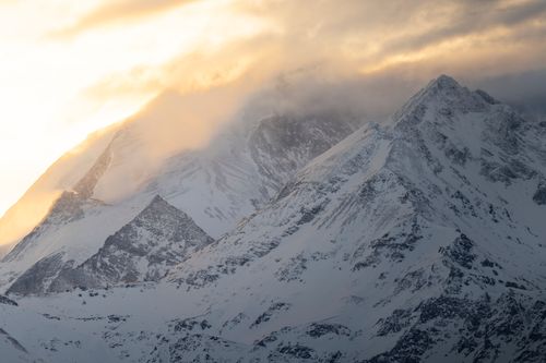 Free Breathtaking view of snow-covered mountains in Crans-Montana, Switzerland during sunset. Stock Photo