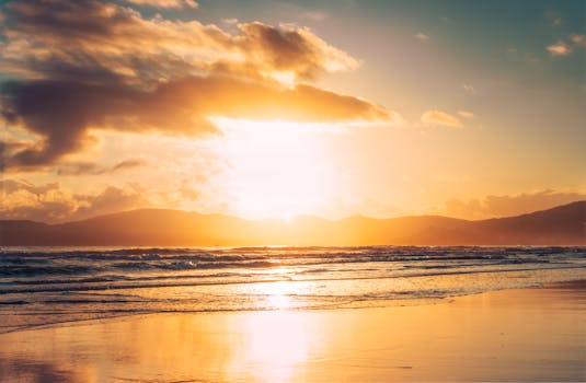 Beautiful sunrise over the sea at Itapema Beach, Brazil, with dramatic sky and waves.