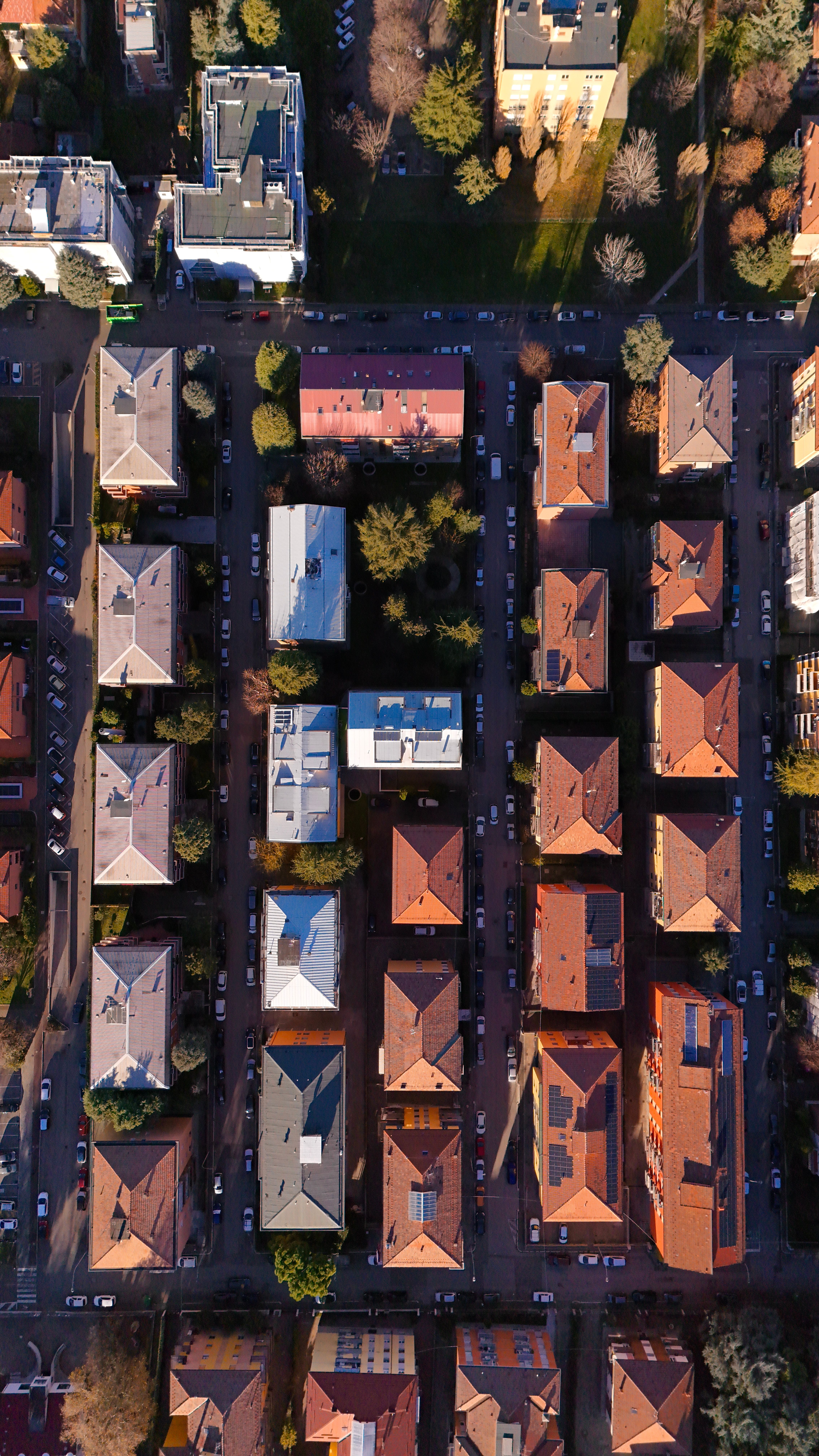 Drone shot over Bologna, Italy, showcasing vibrant rooftops and urban layout.