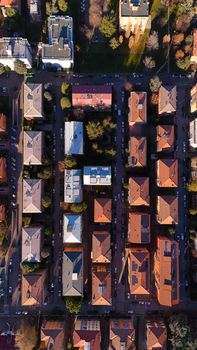 Drone shot over Bologna, Italy, showcasing vibrant rooftops and urban layout.