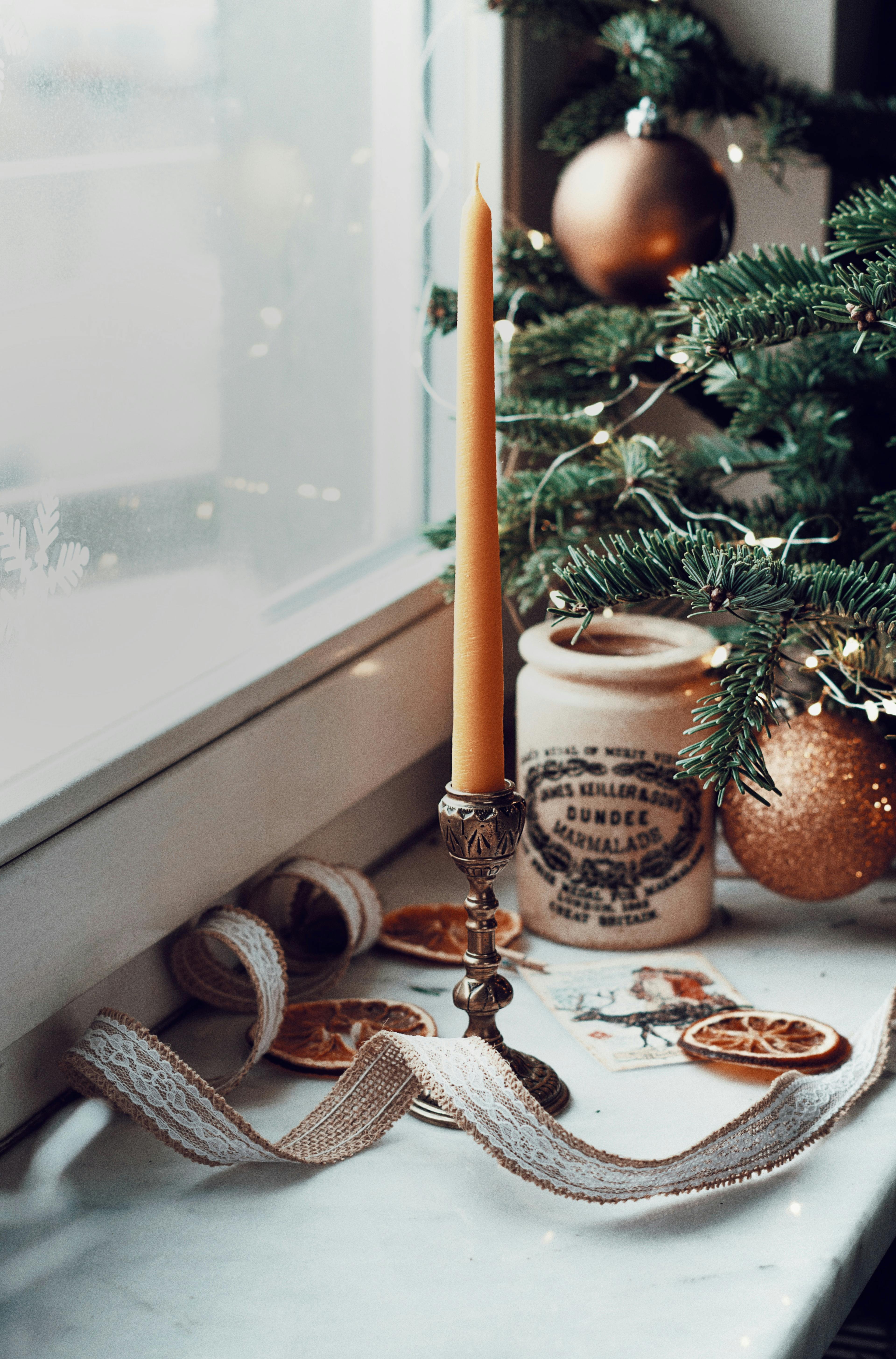 a candle and ornaments on a window sill