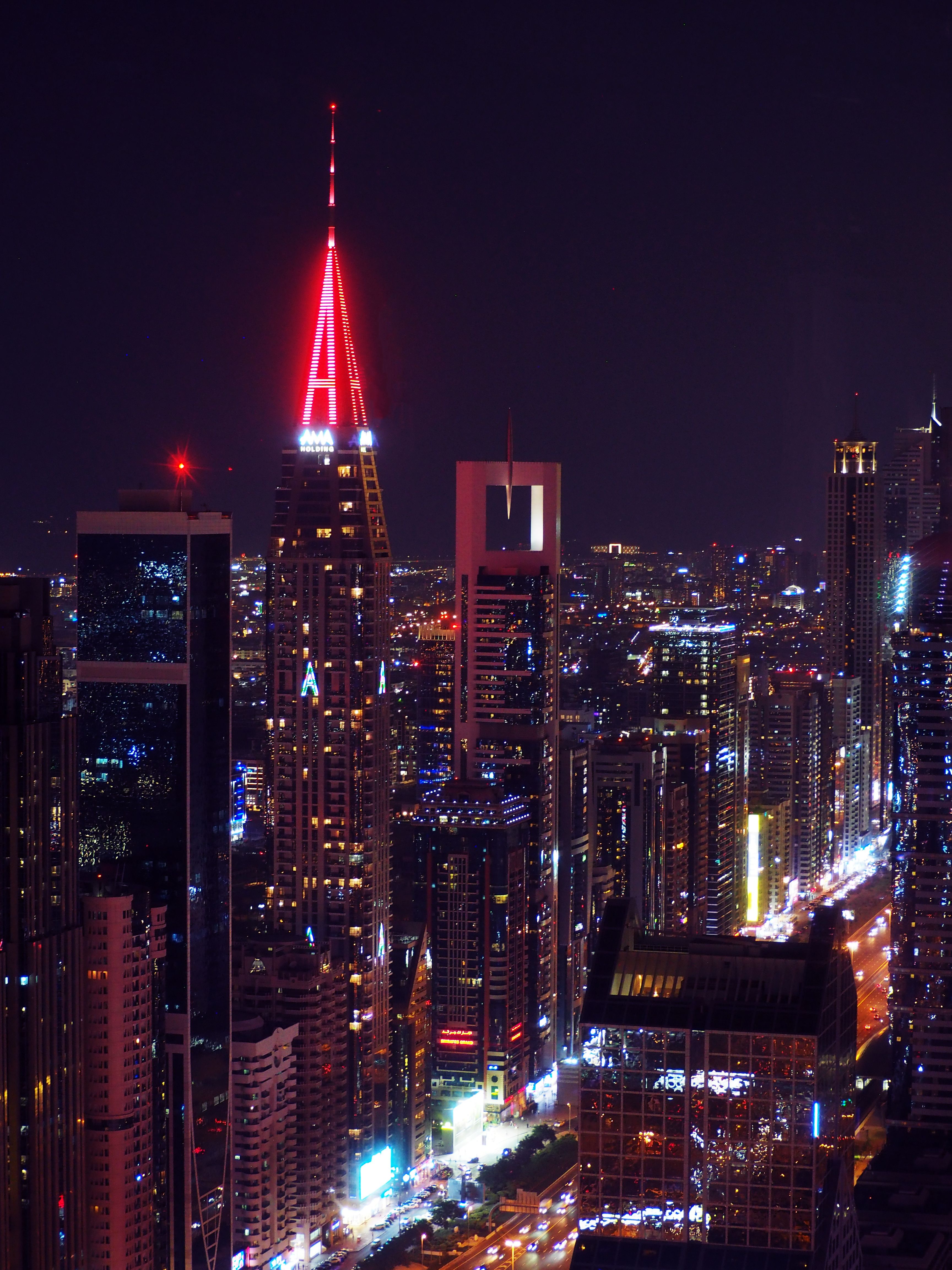 Vibrant Nighttime City Skyline with Neon Lights · Free Stock Photo