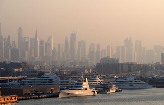 United Arab Emirates eSIM offer: Dubai Marina with luxury yachts against a skyline of iconic skyscrapers in the morning light.
