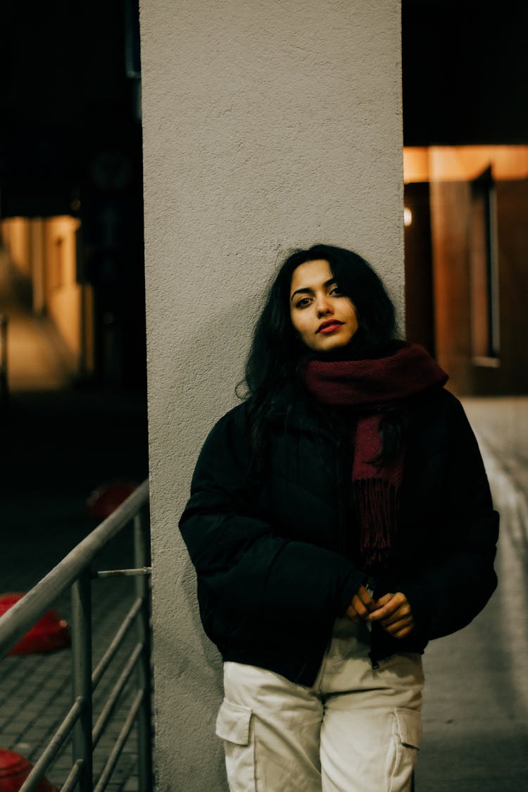 Brunette Woman Posing In Black Puffer Jacket And Maroon Scarf