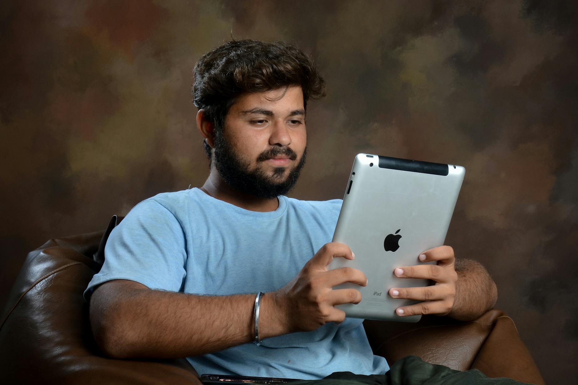 Man in T-shirt Sitting with iPad