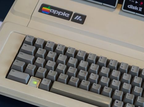 Close-up of a vintage Apple IIc keyboard and Disk II drive in Bletchley, showcasing classic technology.