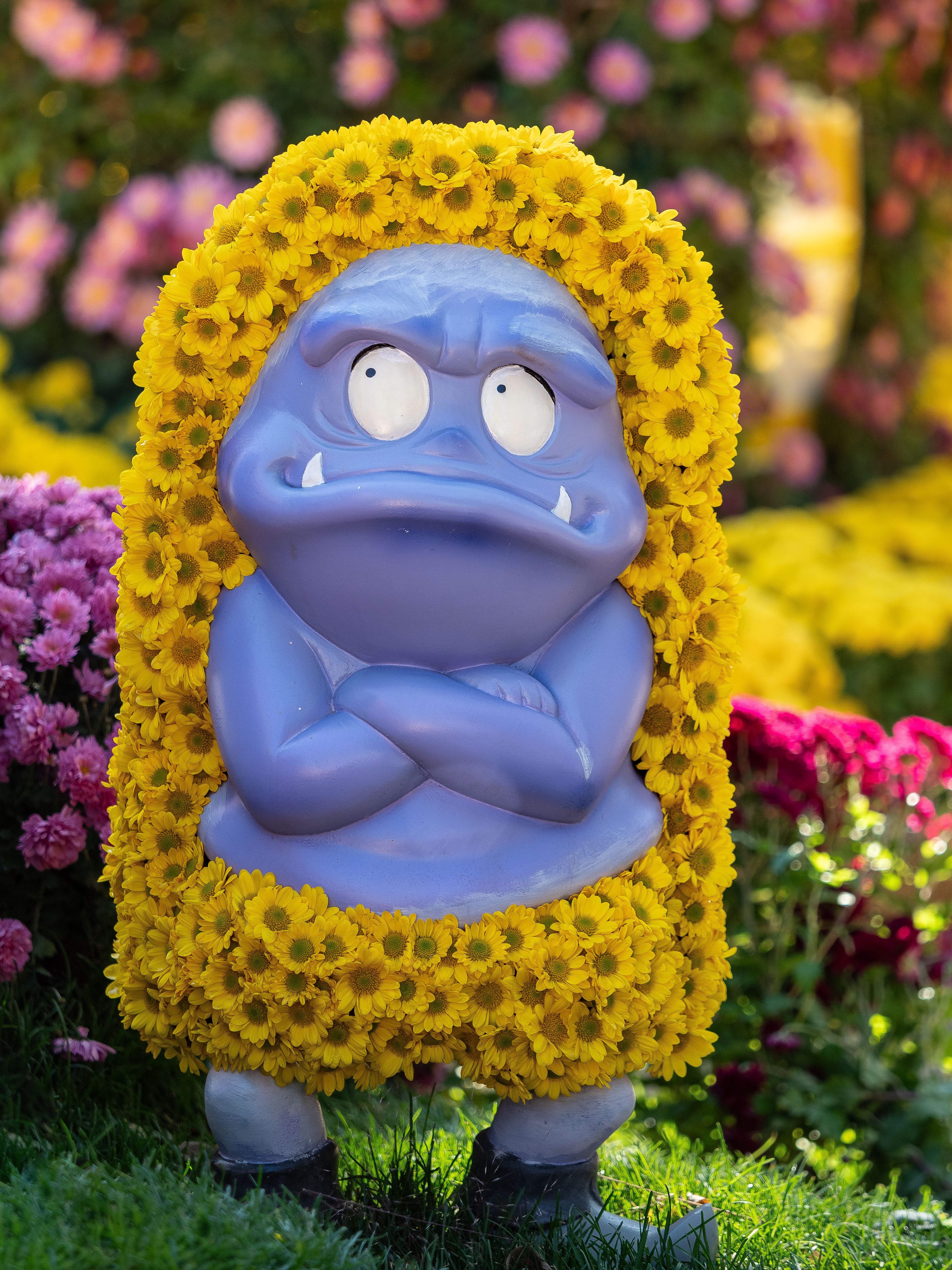 Vibrant figurine covered with yellow blooms in a floral garden in Seoul.