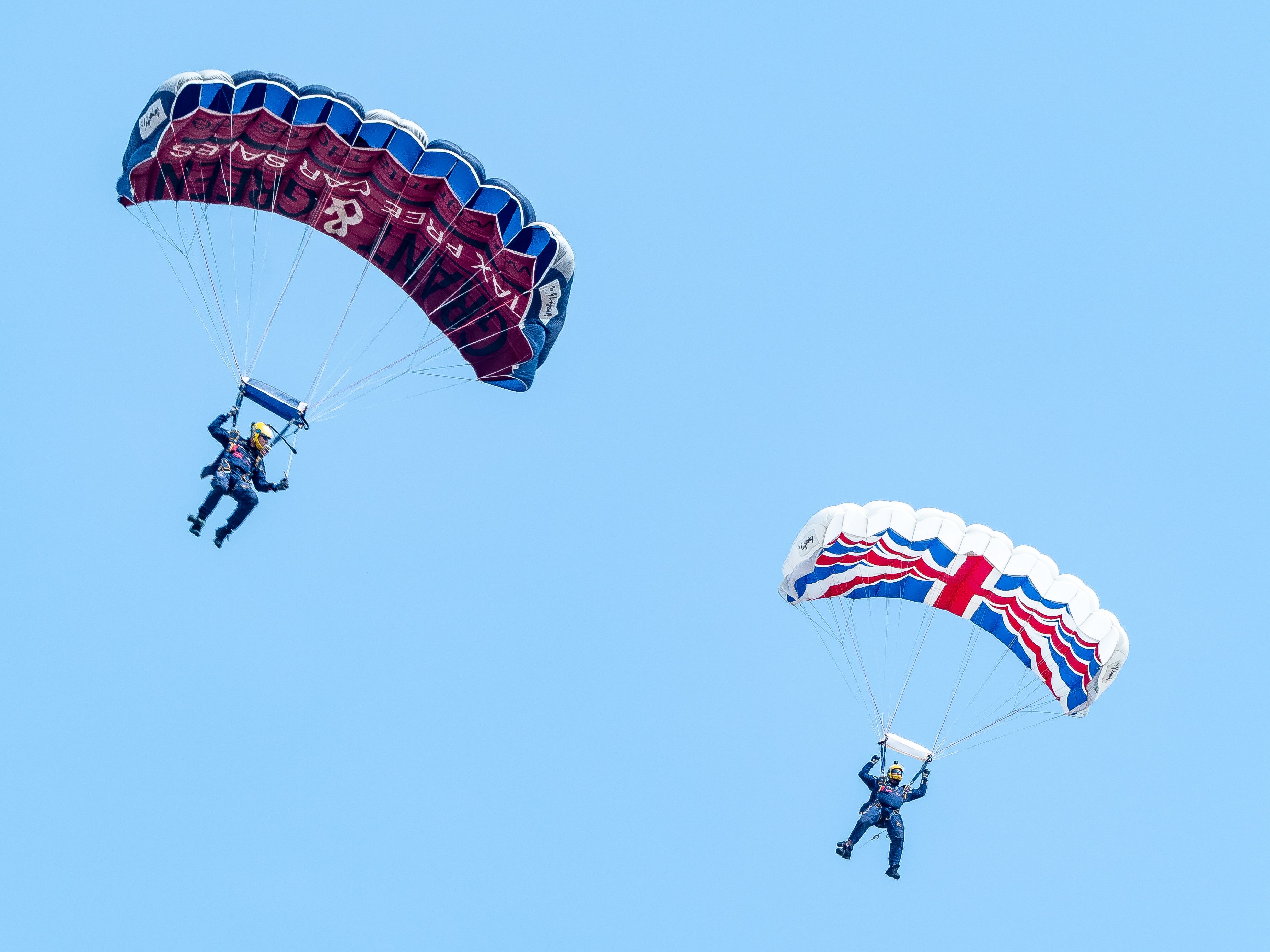 Men Parachuting on Clear Sky · Free Stock Photo