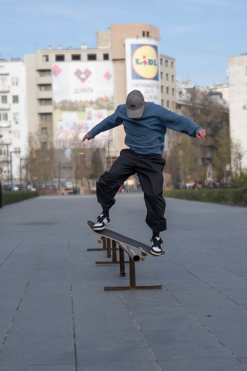 Free Young skateboarder executing a rail trick in Belgrade, Serbia. Urban lifestyle captured in motion. Stock Photo