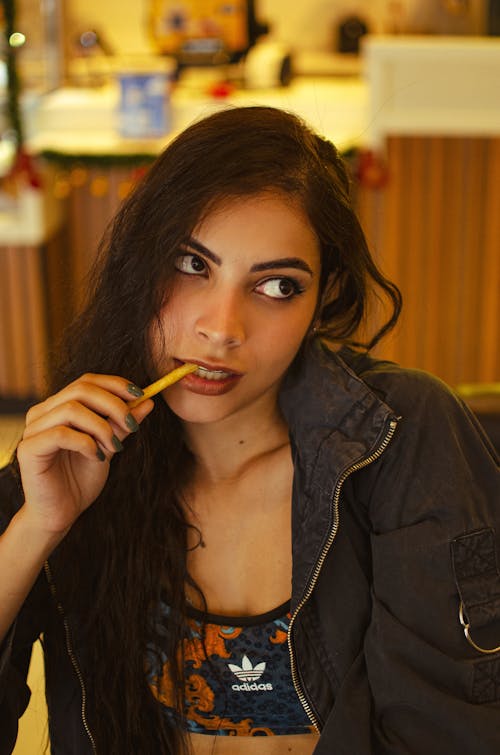 Portrait of Woman Eating French Fry