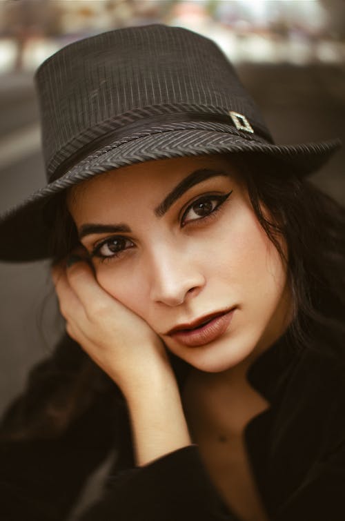 Portrait of Pensive Woman Wearing Hat