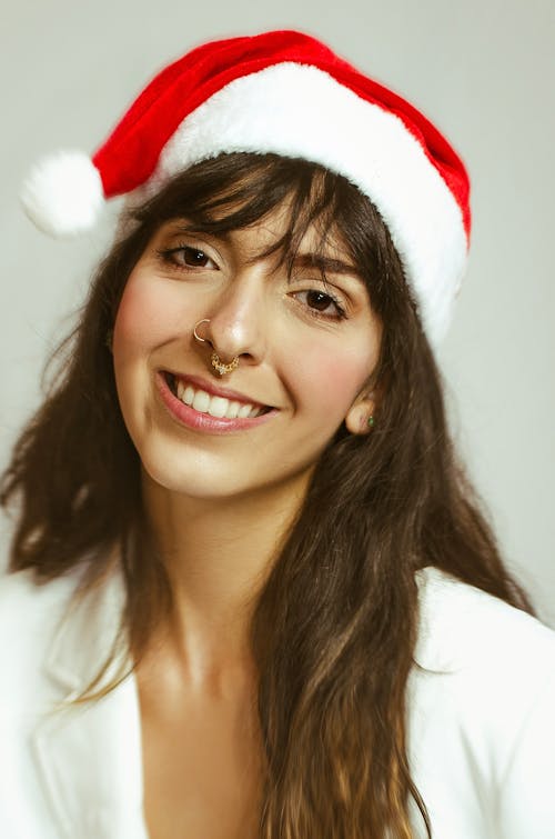 Young Woman with Nose Rings Wearing Santa Hat