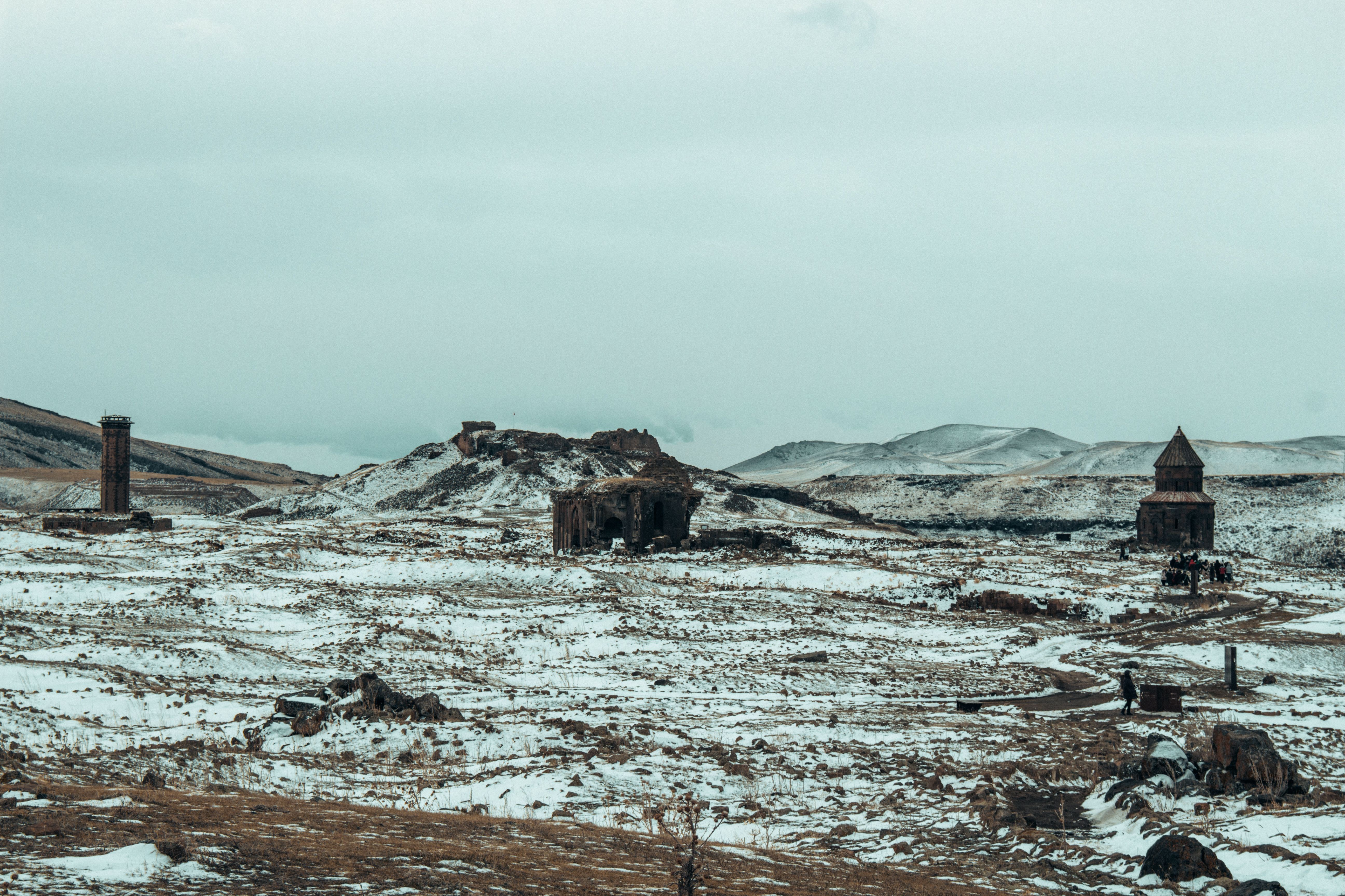 Explore the historic ruins of Ani, Turkey, blanketed with snow, showcasing ancient architecture against wintry hills. — photo by Kuzgunbatu / Pexels
