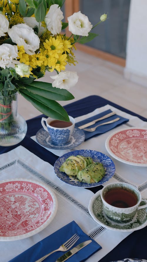 A Table Set for Breakfast with Cups of Tea and Avocado 