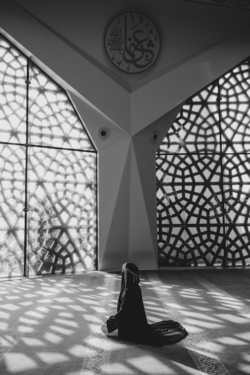 Woman Kneeling and Praying in a Mosque 