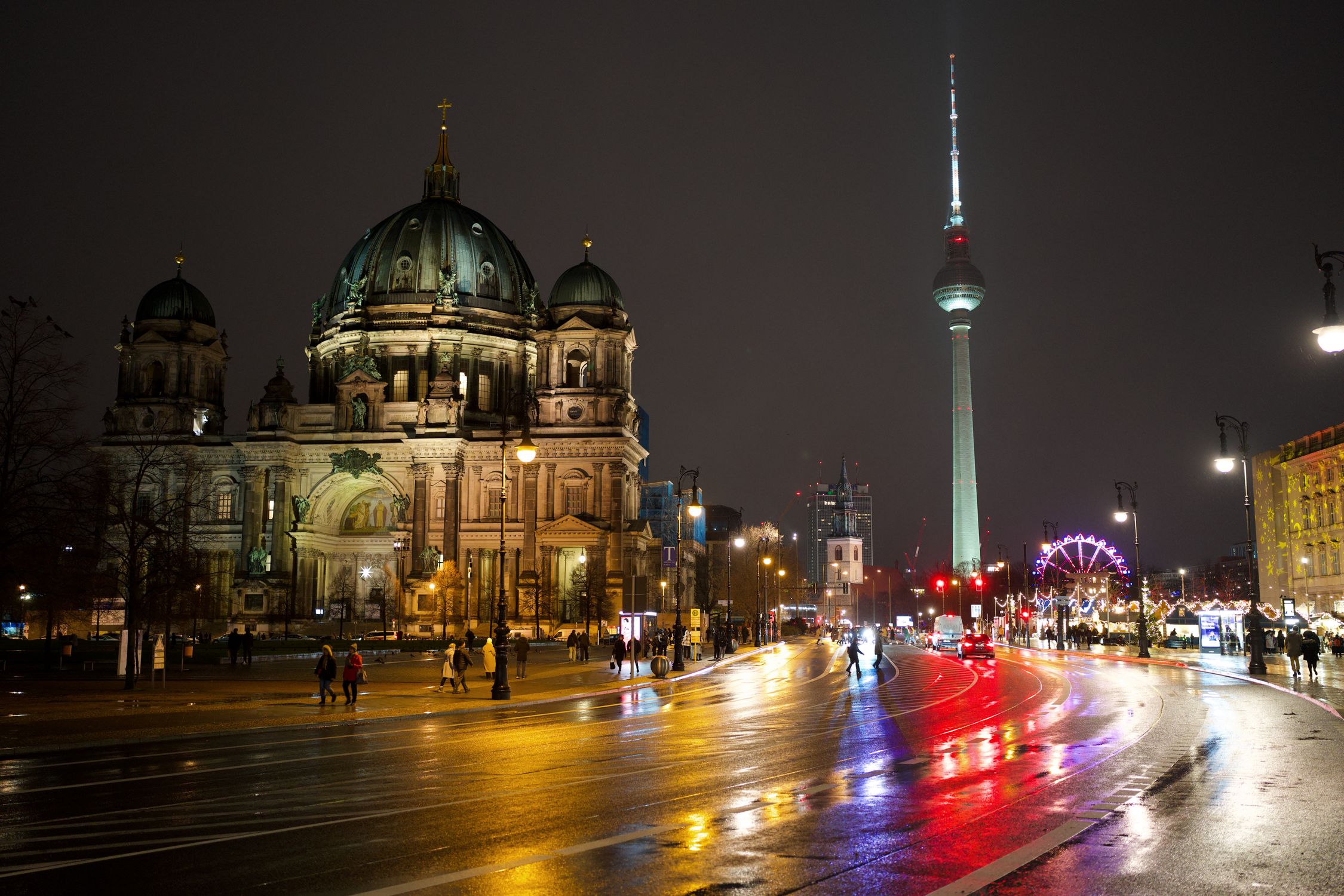 A captivating night scene featuring Berlin Cathedral and Fernsehturm illuminated in Berlin, Germany.