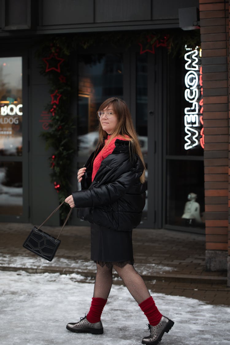 Passerby Walking On Icy Sidewalk And Swinging A Purse