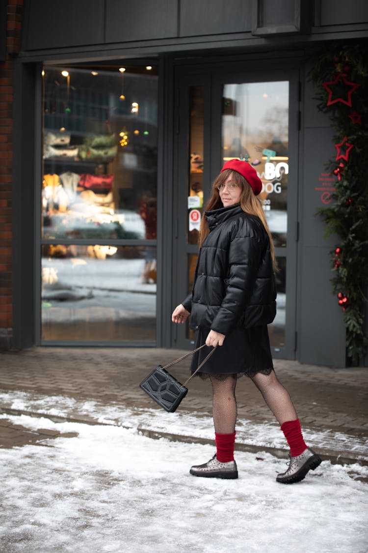 Woman Walking On A Sidewalk In Winter 