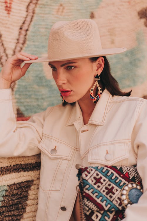 Free Model in a White Jacket and Hat with a Handbag Under Her Arm Stock Photo