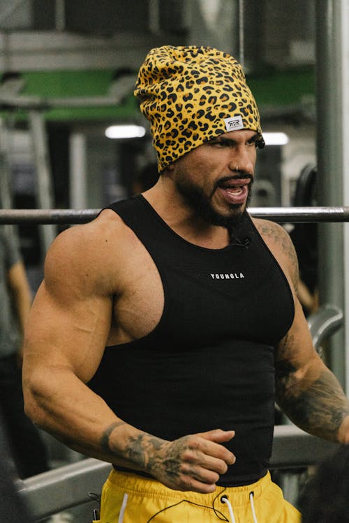 Bodybuilder in a Leopard Print Cap at the Gym · Free Stock Photo