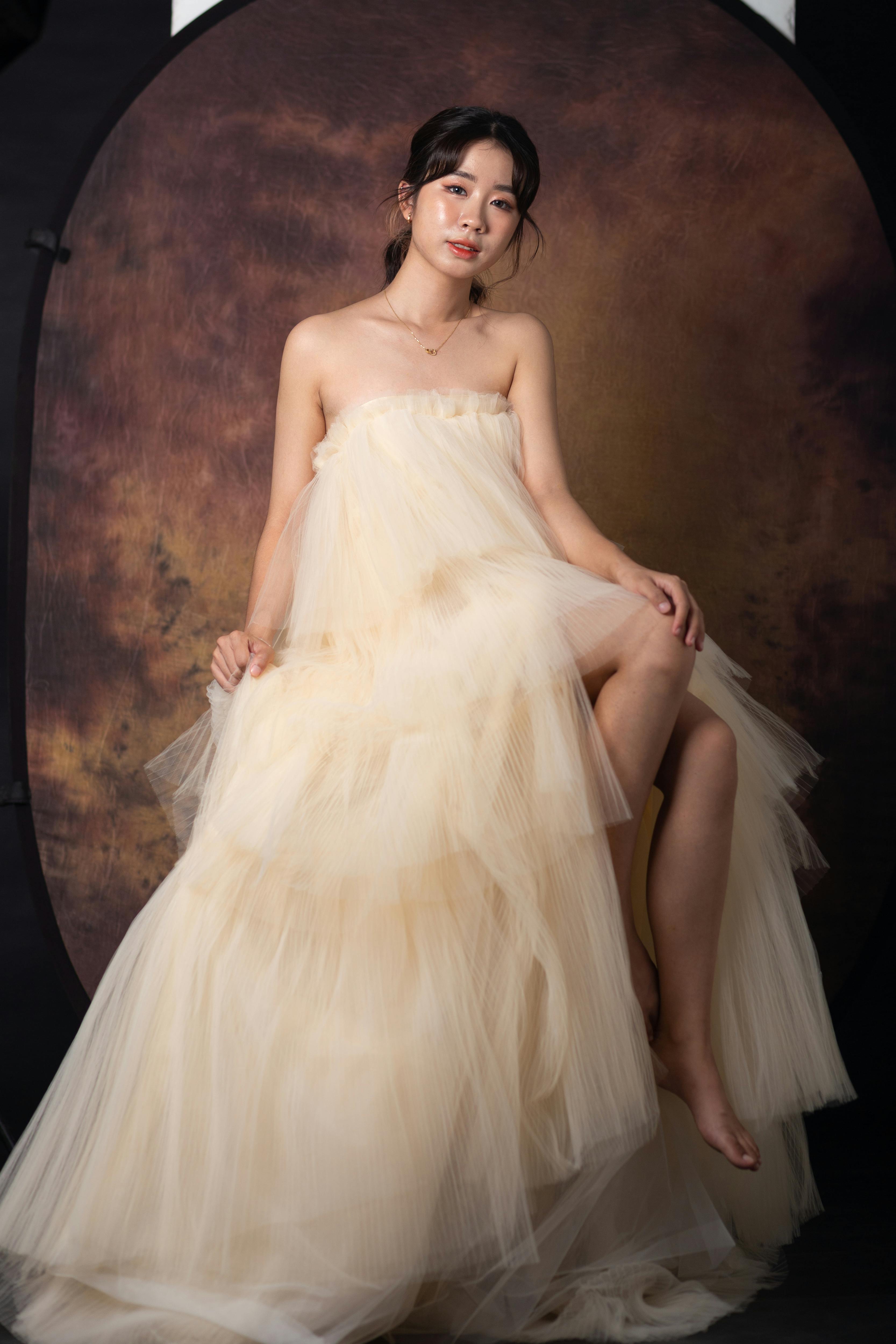 Exquisite bridal portrait with a model in a flowing gown, captured in a studio setting.