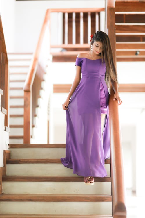 Woman in Purple Dress on Stairs