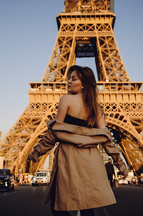 A Woman Standing in Front of the Eiffel Tower