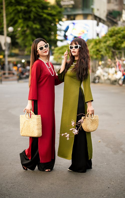 Women Wearing Dresses on a Street 