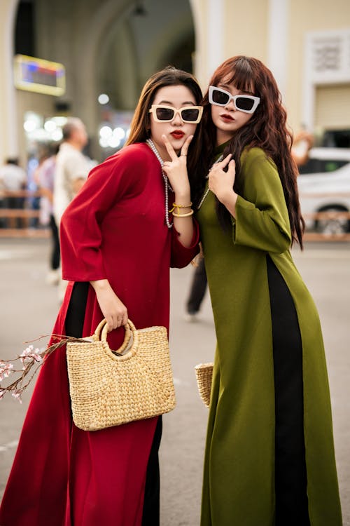 Women Wearing Dresses on a Street 