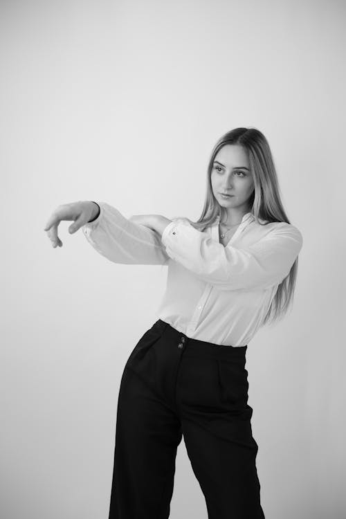 Young Woman Pointing Away From The Camera