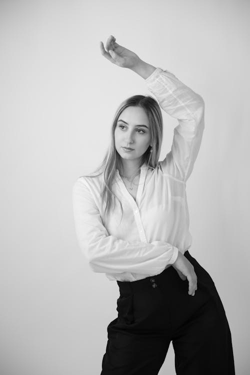 Model in a Blouse and Pants Posing in a Studio