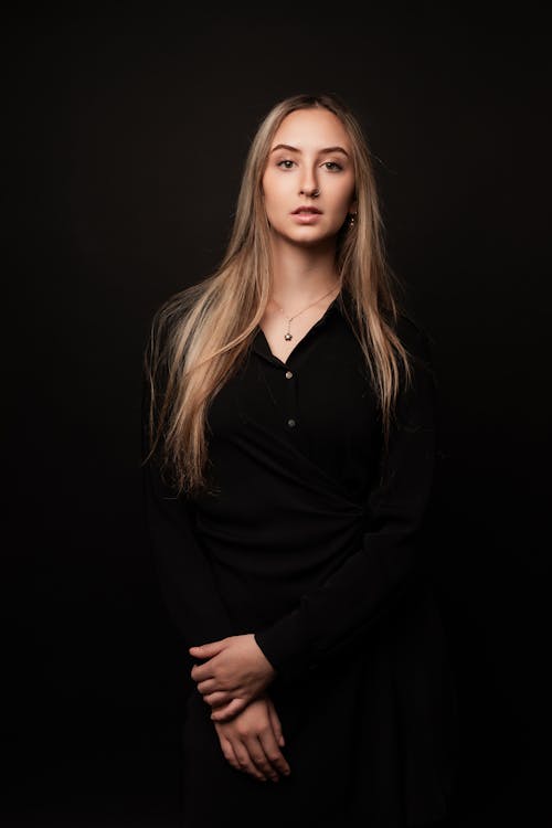 Model Posing in the Studio Wearing a Black Dress