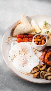 A savory breakfast plate featuring fried eggs, beans, toast, and vegetables.