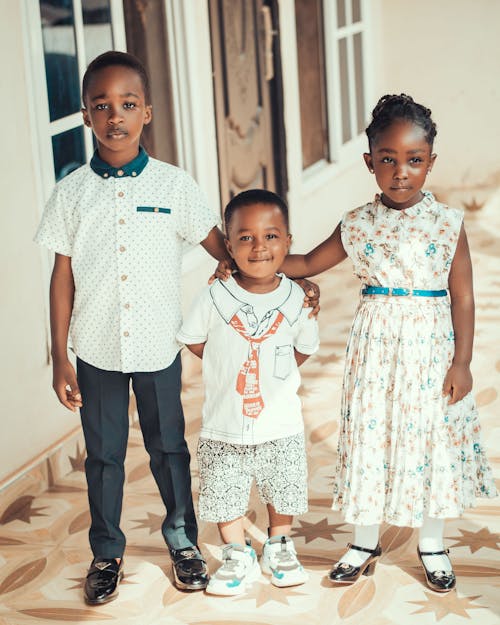 Three Children Standing Together 